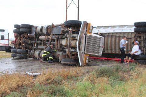 Semi-truck overturns, driver sent to hospital